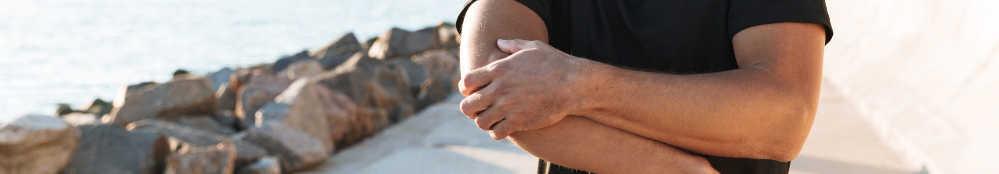 Photo of man clutching his elbow